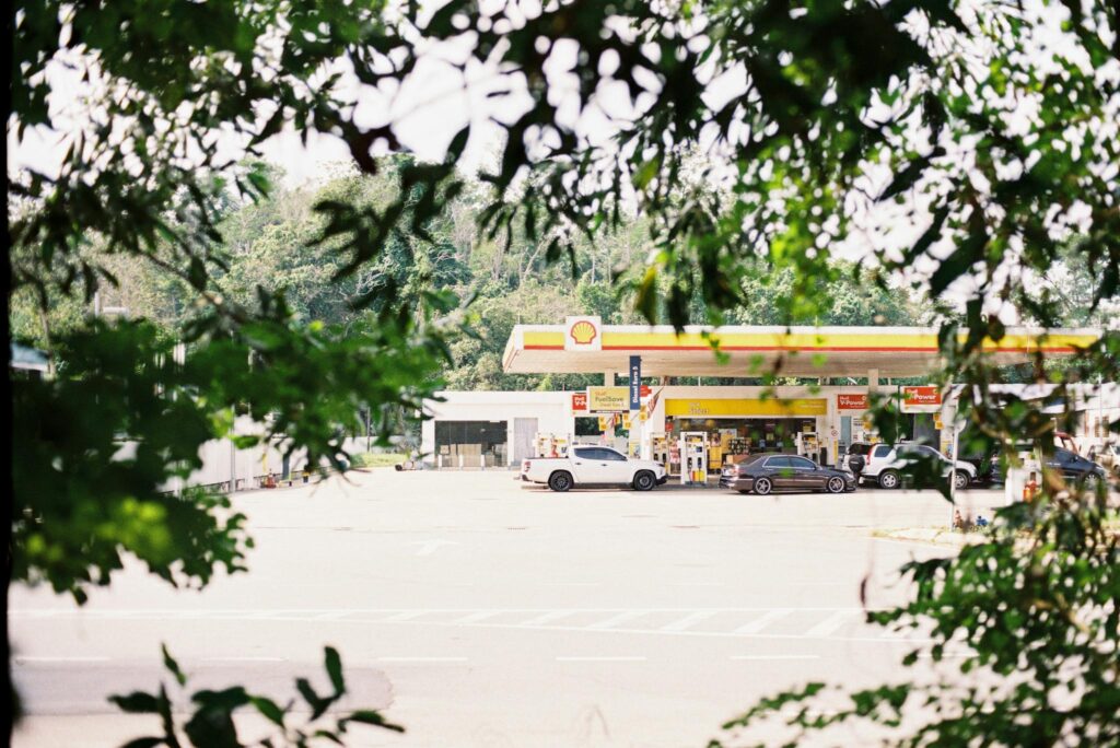 A gas station is seen through the trees