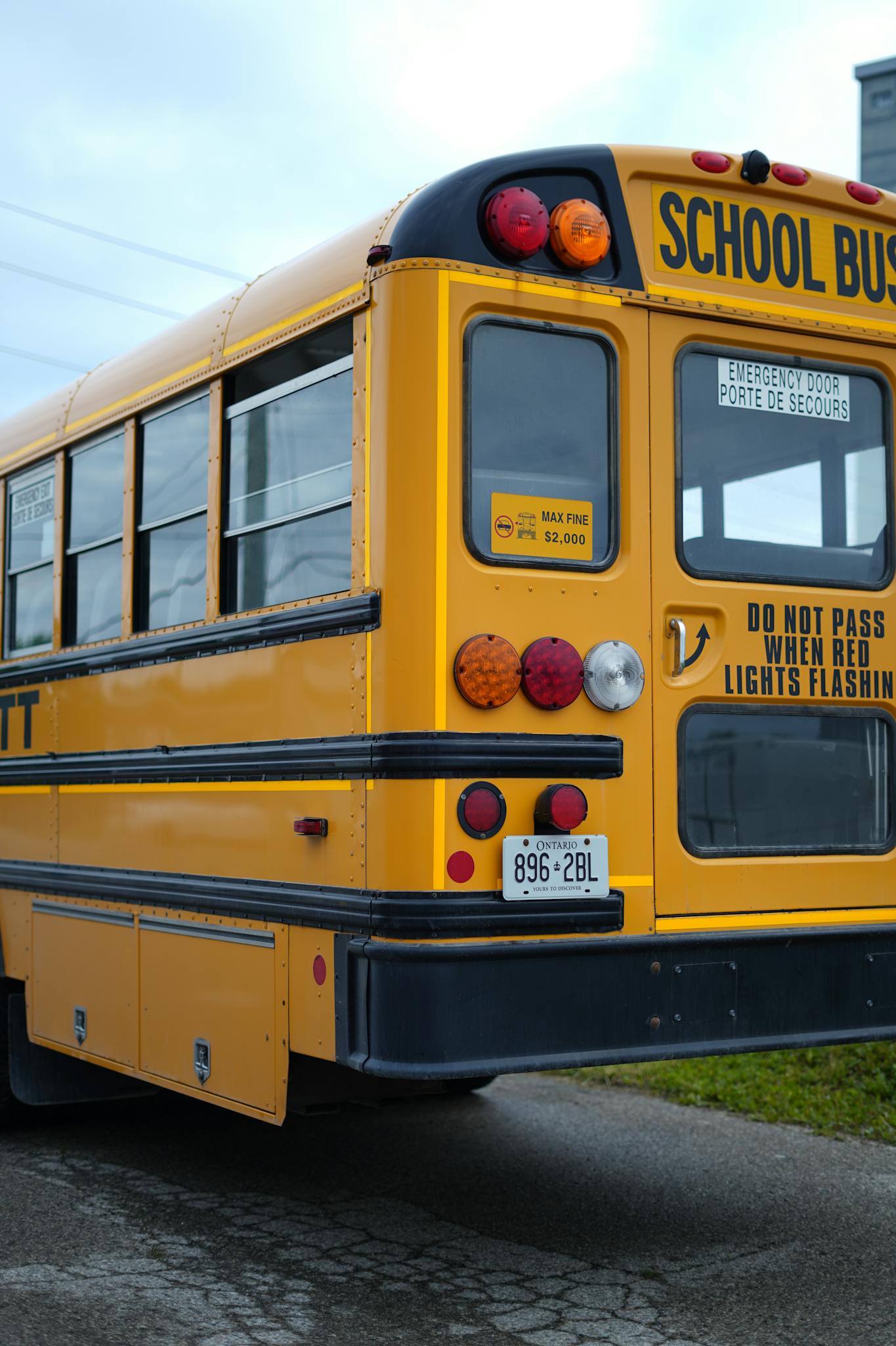A classic yellow school bus parked on a street in Kitchener, Ontario, Canada.